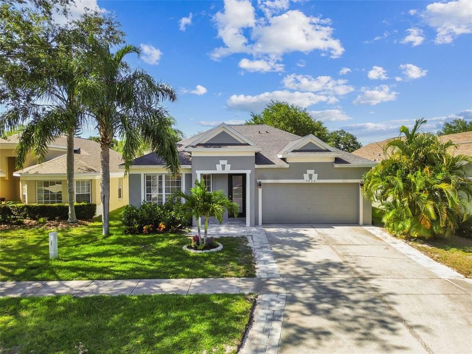 Beautiful landscaping and extended driveway with pavers