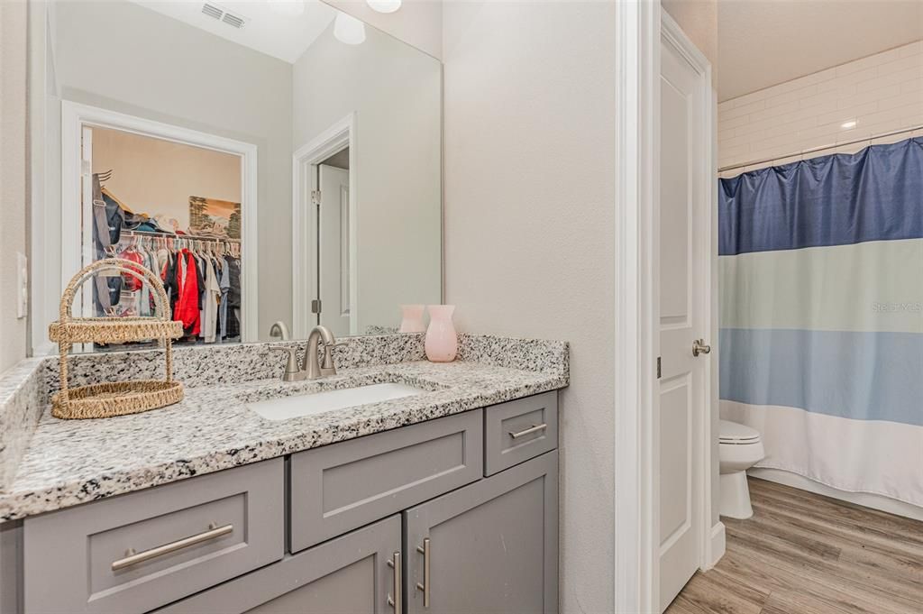 bathroom with separate sinks but sharing shower/tub