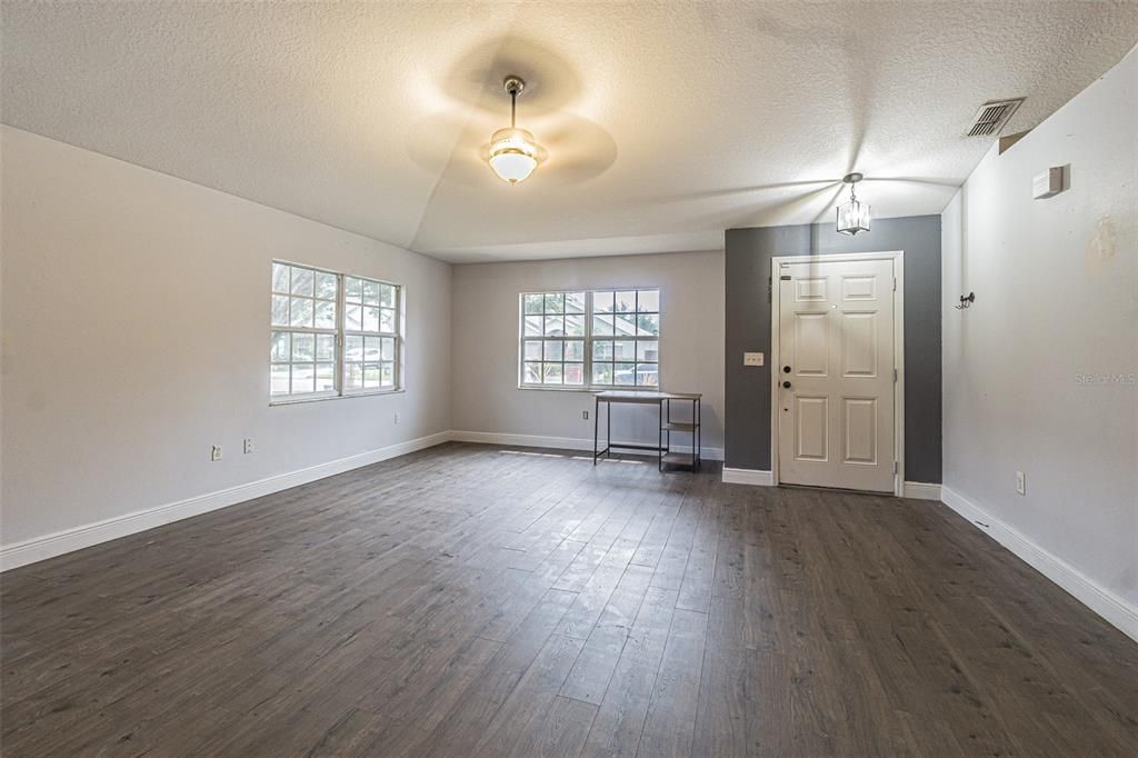 Spacious living room with high ceilings and plant shelves