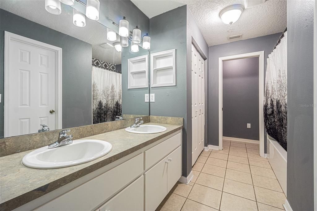 ensuite bath with dual vanities, extra large linen closet and private water closet at the back.