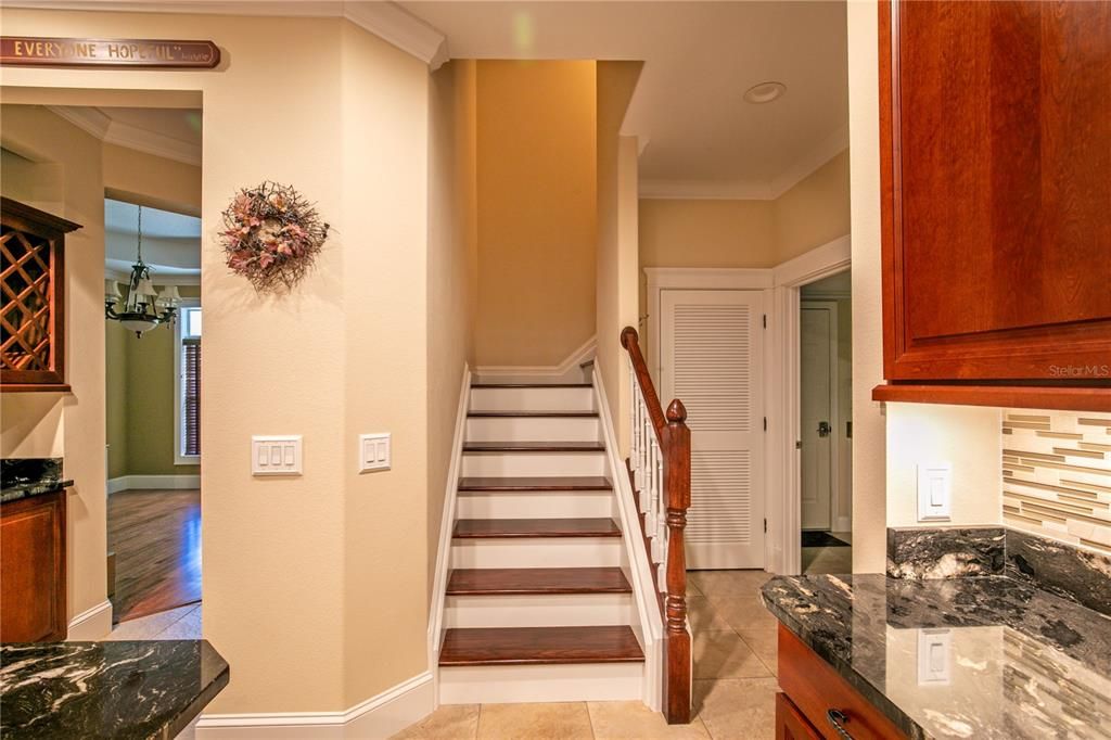 stairs from kitchen lead to upper level