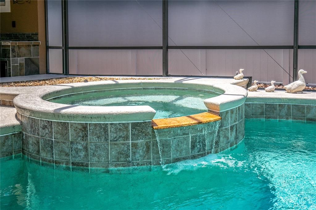 spa with waterfall to pool