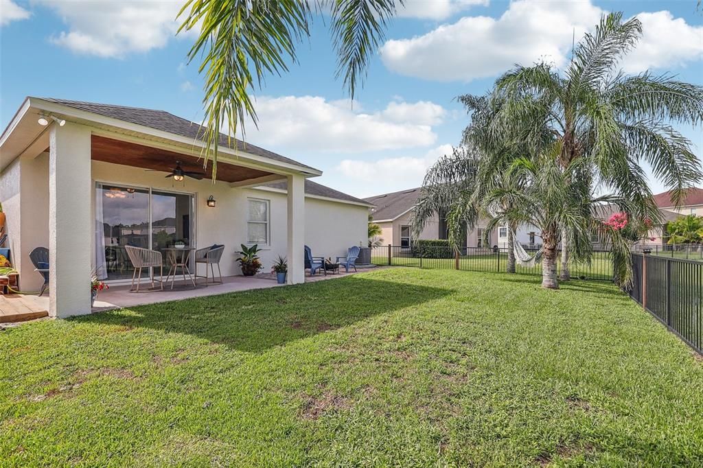 There are privacy palms at every window as well as in your backyard adding to the coastal vibe, and the FENCED YARD, WATER VIEWS and COVERED LANAI with an EXTENDED PAVER PATIO turn your outdoor space into an oasis to be enjoyed!