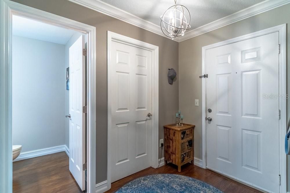 Foyer leads to the Guest Bath, storage, and Laundry