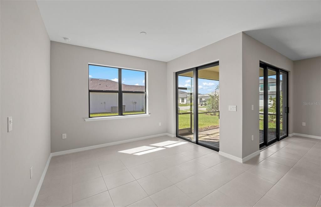 Cafe with sliding glass door onto screened in lanai