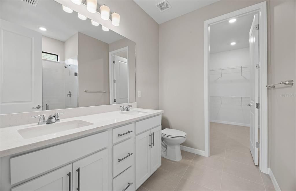 Master bath leading to walk-in closet