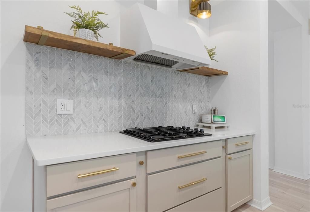 Range hood, gas range top, custom floating wood shelves