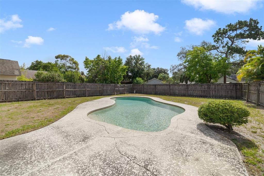 Large fenced yard with sparkling pool