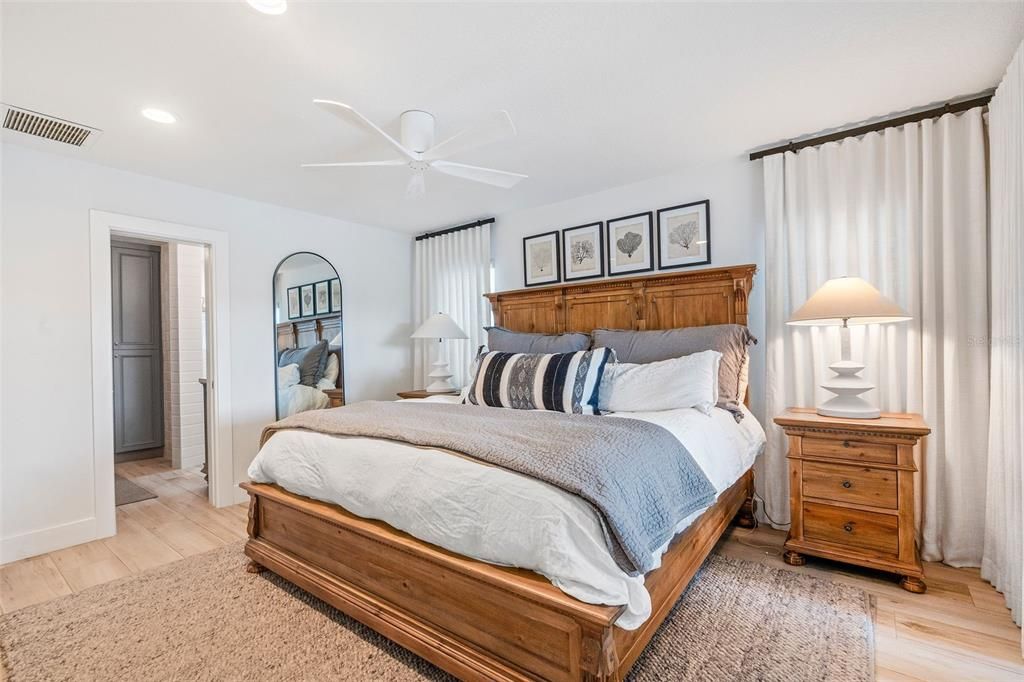 Primary bedroom with custom Restoration Hardware window treatments