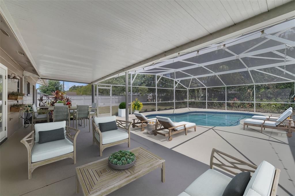 Step out onto the screened lanai and imagine a backyard oasis, with your sparkling pool at the center of it all, overlooking an expansive FENCED BACKYARD with a paver patio/fire pit and a wide variety of mature landscaping and fruit trees (lemon, lime, orange, banana, grapefruit and even pineapple plants)! Virtually Staged.