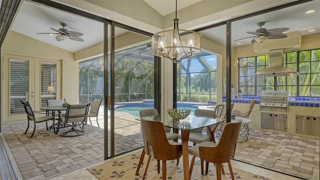 Dinette overlooking summer kitchen, patio and pool