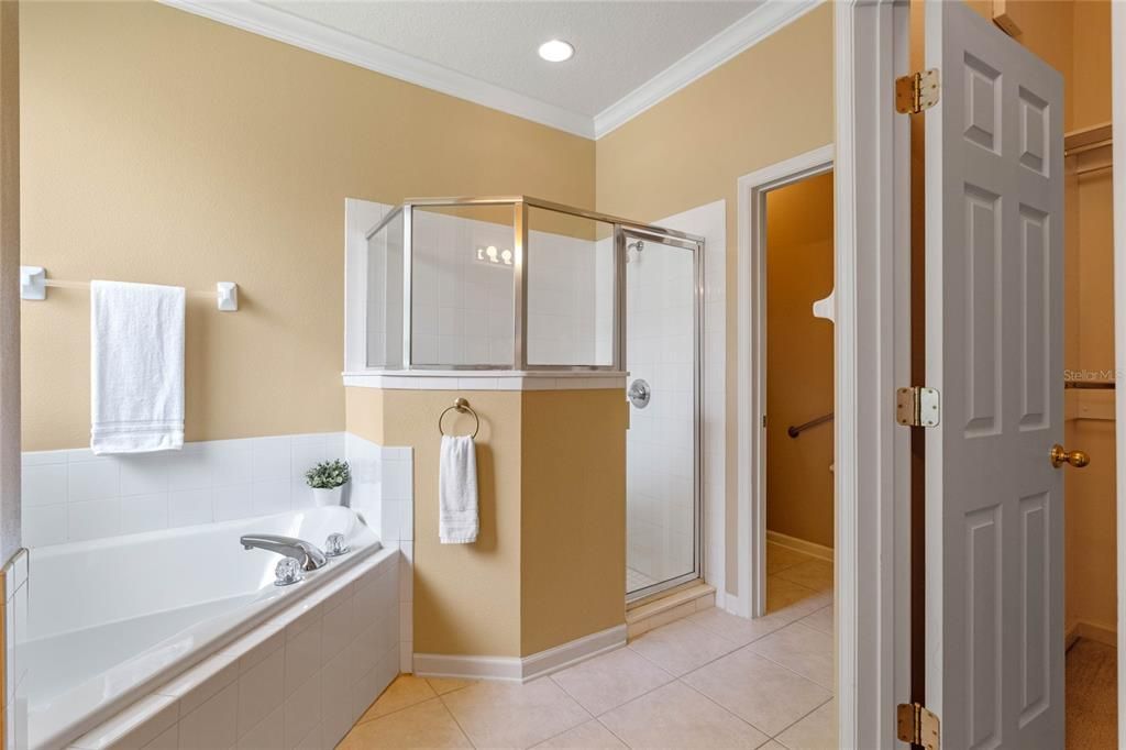 Primary Bath w/ glass enclosed walk-in shower, soaking tub & walk-in closet