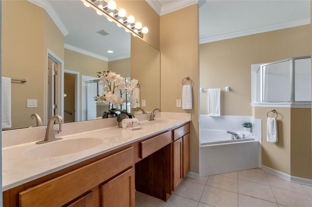 Primary Bathroom w/ dual sinks, corner soaking tub & glass enclosed walk-in shower