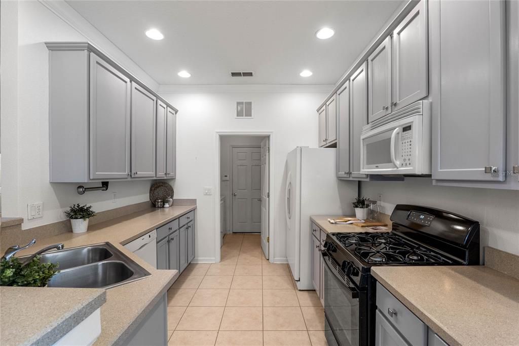 View of Kitchen w/ 42" cabinets, crown molding & a natural gas range