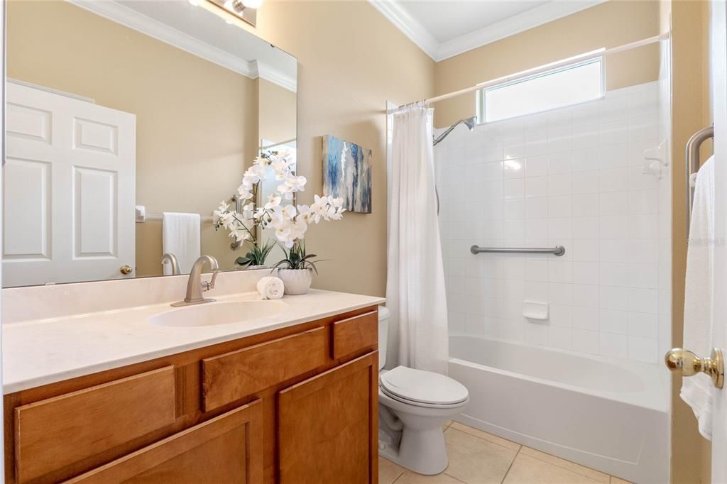 9' x 5'6" Guest Bath w/ raised height vanity, tub/shower combo & grab bars