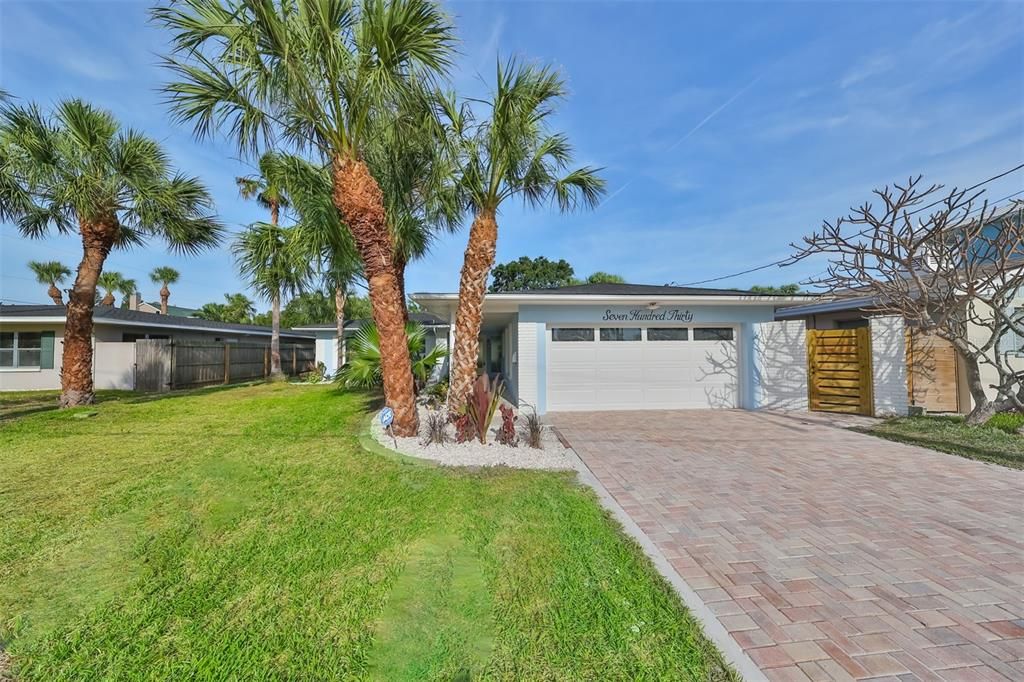 View of the front of the home with paver driveway