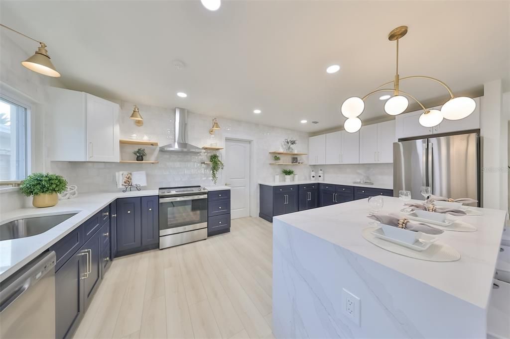 Floating shelves with dramatic strategic lighting complement the kitchen design