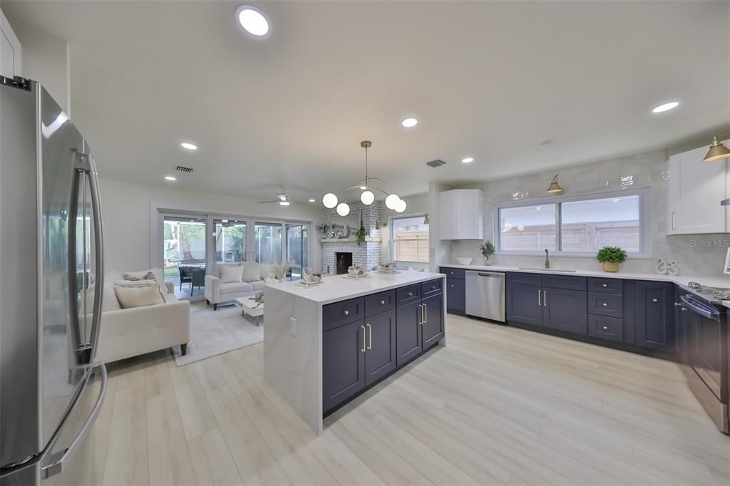 This grand kitchen design boasts loads of cabinets and counterspace