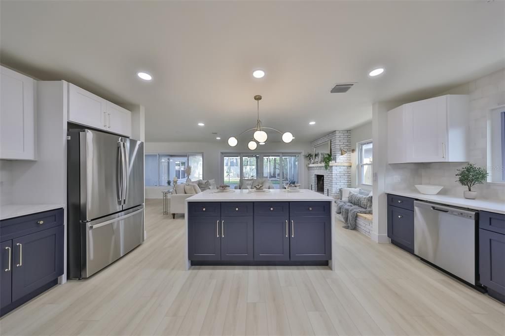 The blueberry lower cabinets with white uppers cabinets creates a striking beach vibe