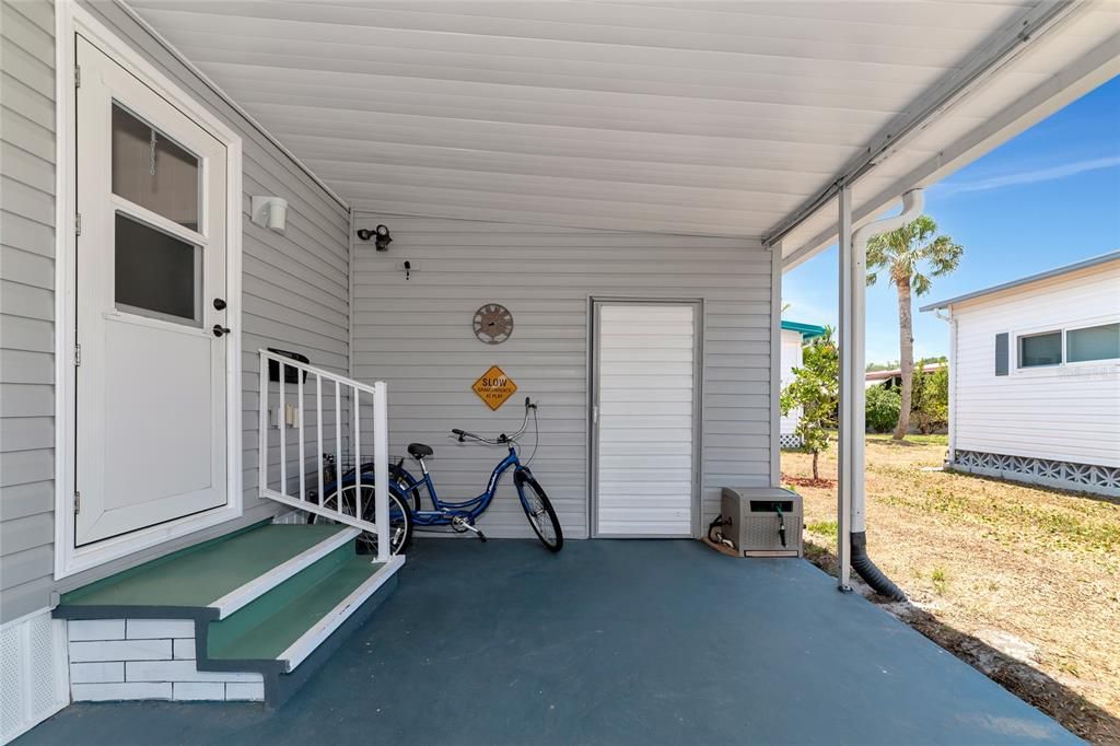 Carport with door to storage/laundry/woodworking room