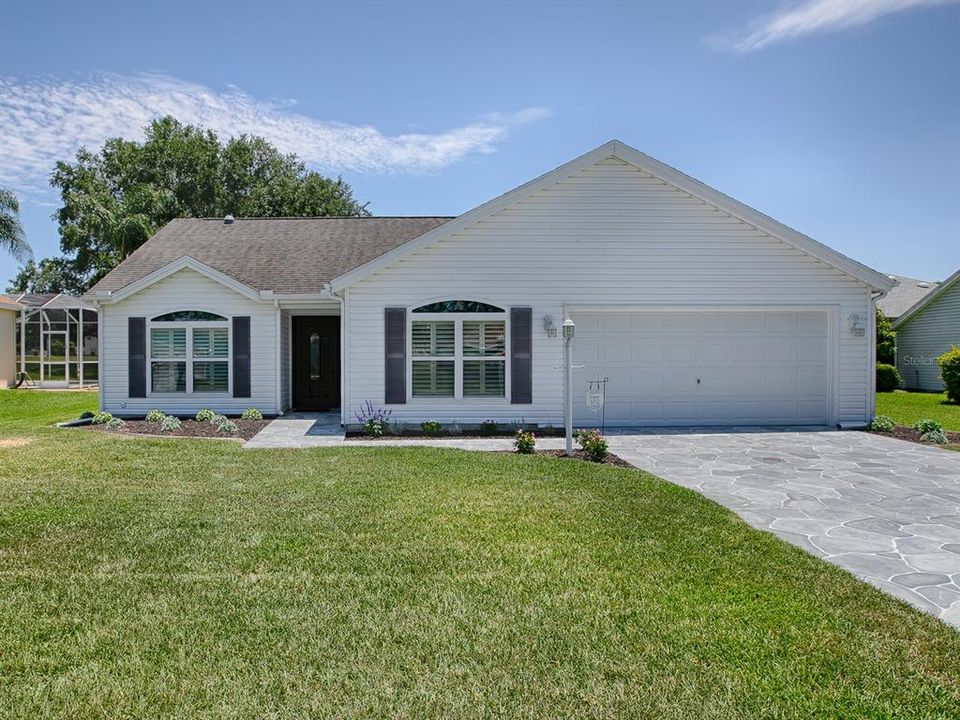 GREAT CURB APPEAL HERE... A WELL-MANICURED LAWN, A BEAUTIFUL DRIVEWAY AND WALKWAY TO THE FRONT ENTRANCE