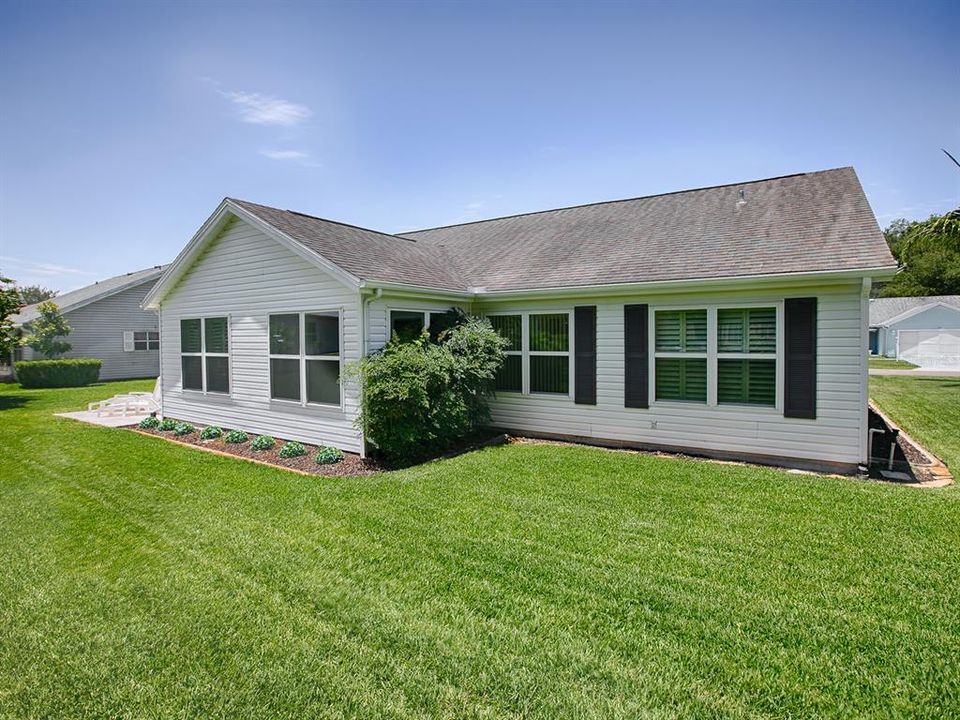 VIEW OF THE BACK OF THE HOME... LOOK AT THAT METICULOUSLY CARED-FOR LAWN!