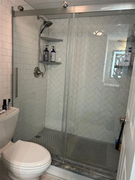 Stunning tile designs this glass enclosed Master bath shower.