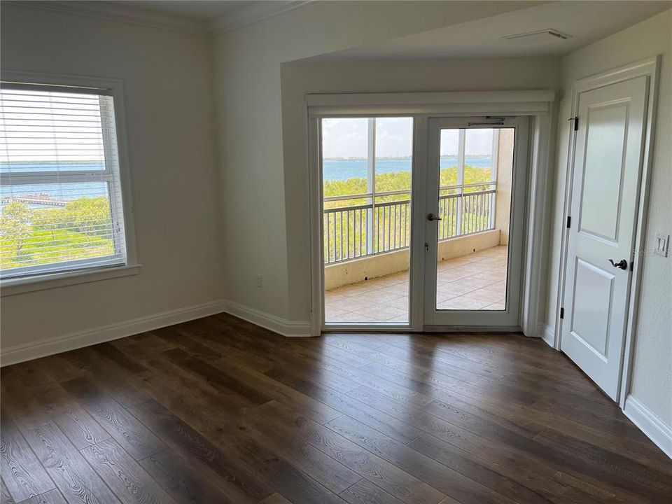 Primary bedroom with door to screened patio