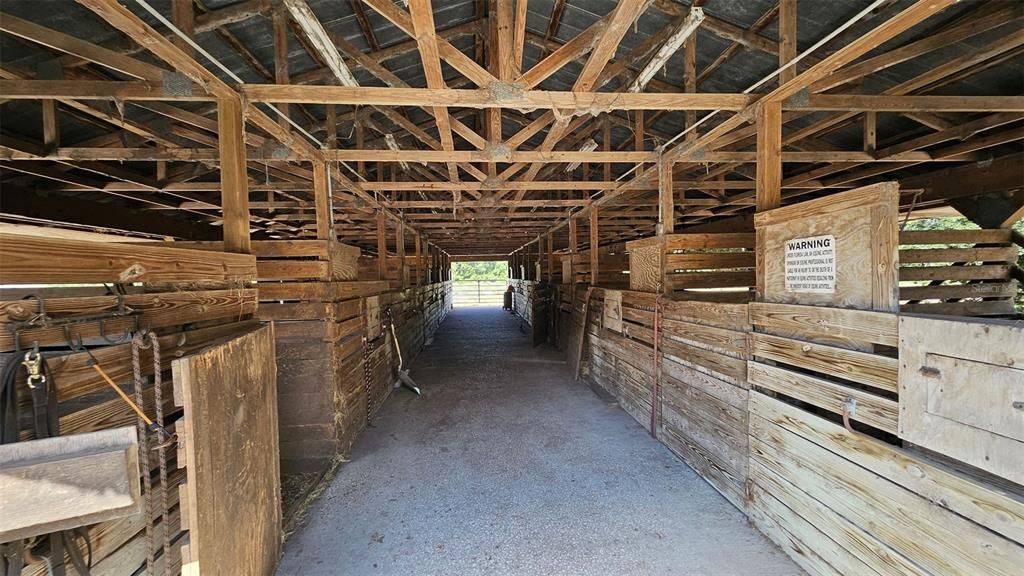 inside the 12 stall barn with concrete isle