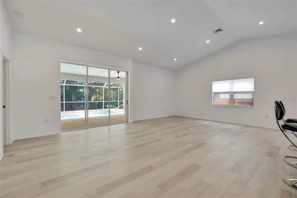 Airy & Bright Great room with 3 panel stacking sliding glass doors and large windows