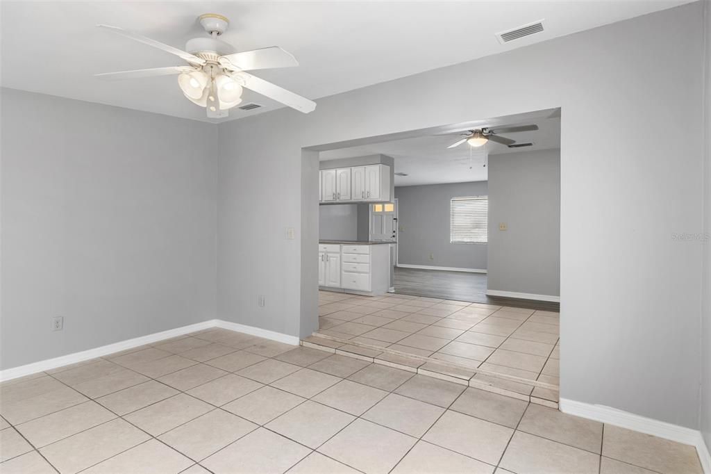 View of the step down Bonus Room looking into the formal dining room