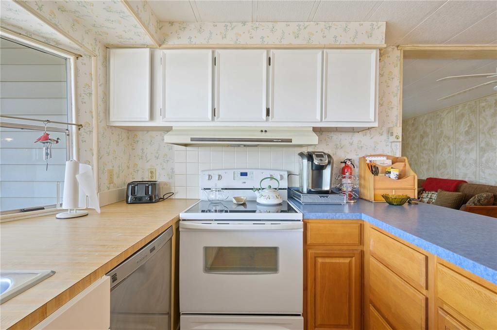 Kitchen has updated cabinets, some counter tops, and laminate flooring.