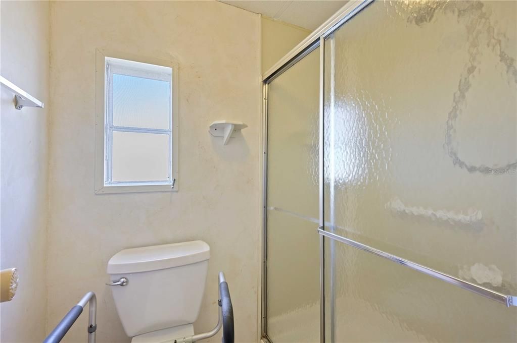 Step-in shower in this bathroom.