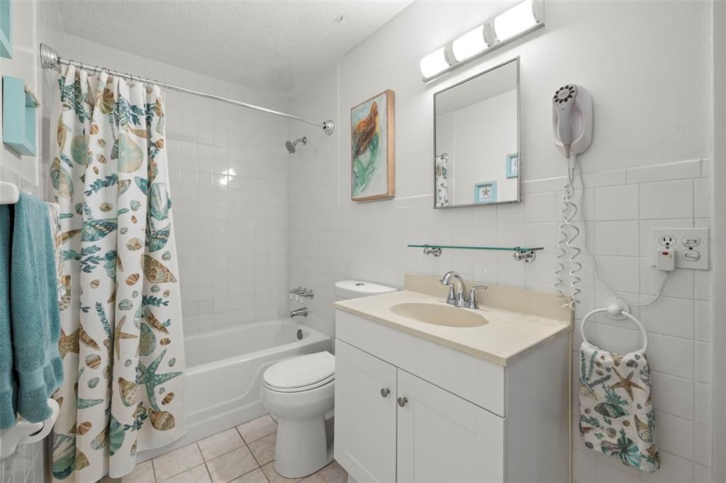 Renovated bathroom with updated vanity, comfort height toilet as well as updated lighting.