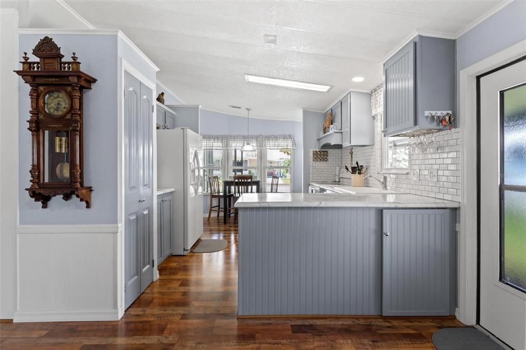 VIEW OF ENTRY AT SIDE DOOR, KITCHEN AND EAT-IN AREA