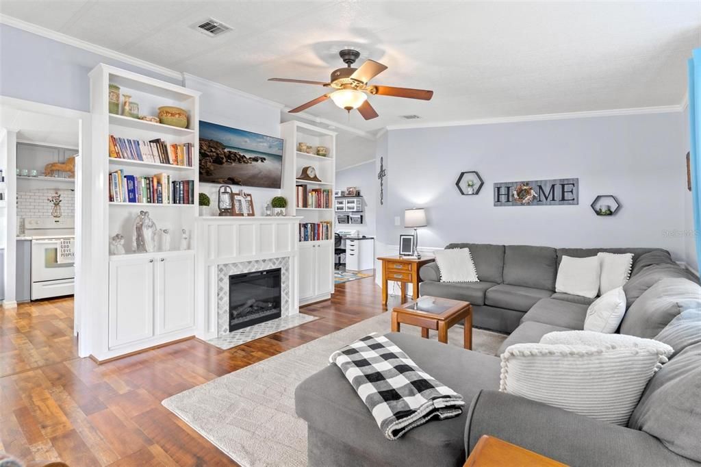 VIEW OF CUSTOM BOOKSHELVES AND FIREPLACE IN LIVING ROOM