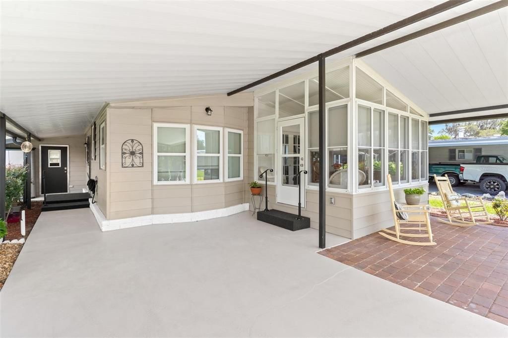 CARORT AREA, COVERED PORCH AND VIEW OF SUN ROOM