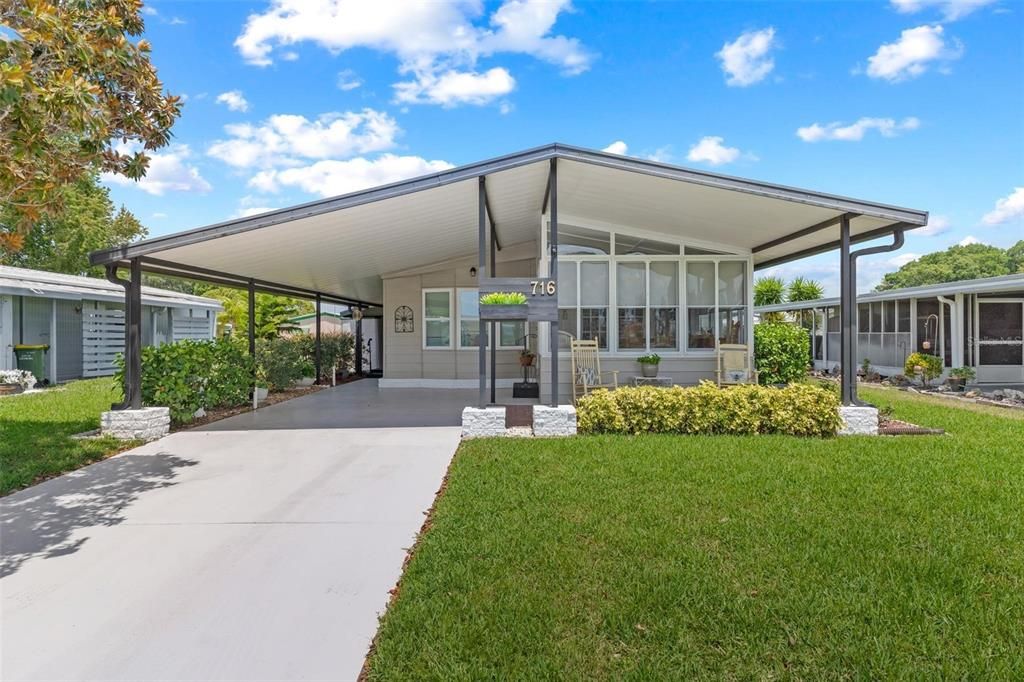 FRONT VIEW OF PROPERTY, OPEN PATIO PORCH AND CARPORT AREA