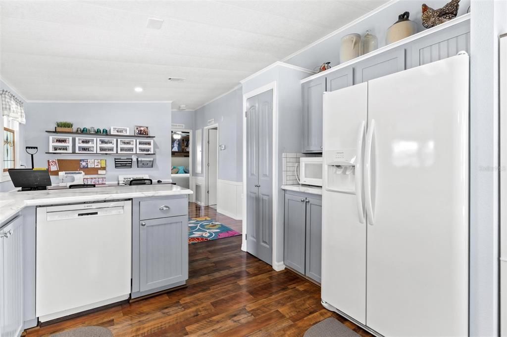 KITCHEN WITH UPDATED APPLIANCES, PANTRY AND VIEW OF CRAFT AND SEWING AREA