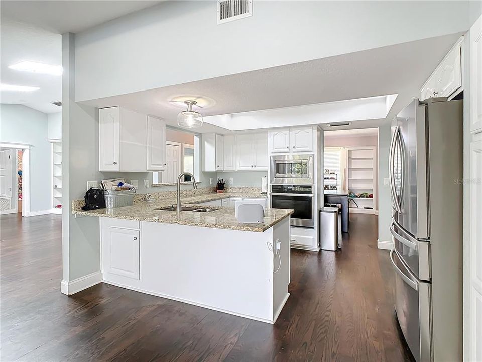 The kitchen opens to the living room and informal dining area.