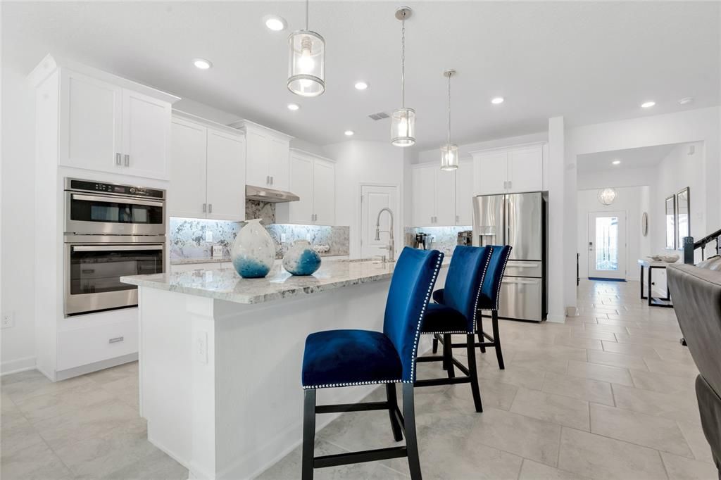 This light and bright OPEN CONCEPT has CERAMIC TILE FLOORS throughout the main living areas, high ceilings, formal dining area and the many windows let the NATURAL LIGHT pour through and set everything aglow.