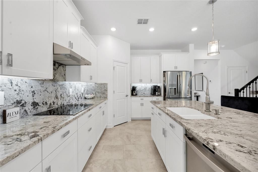 The family chef will delight in the chic kitchen delivering SHAKER STYLE CABINETRY with custom hardware and topped with crown molding, STONE COUNTERS and BACKSPLASH, STAINLESS STEEL APPLIANCES, WALK-IN PANTRY and the breakfast bar on the ISLAND makes it easy to entertain family and friends.