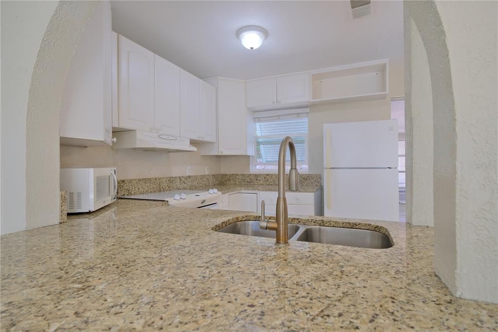 OPEN KITCHEN WITH INVITING ARCHED SPACES!