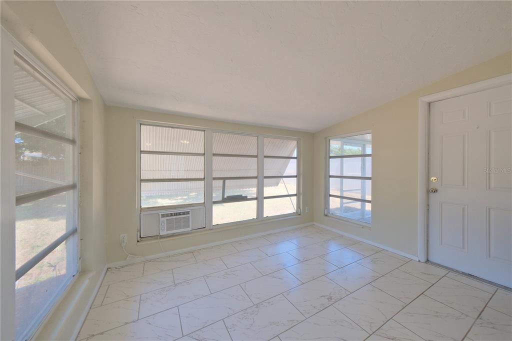 UNDER ROOF FLORIDA ROOM/LANAI WITH SCREEN PORCH ACCESS TO BACKYARD.