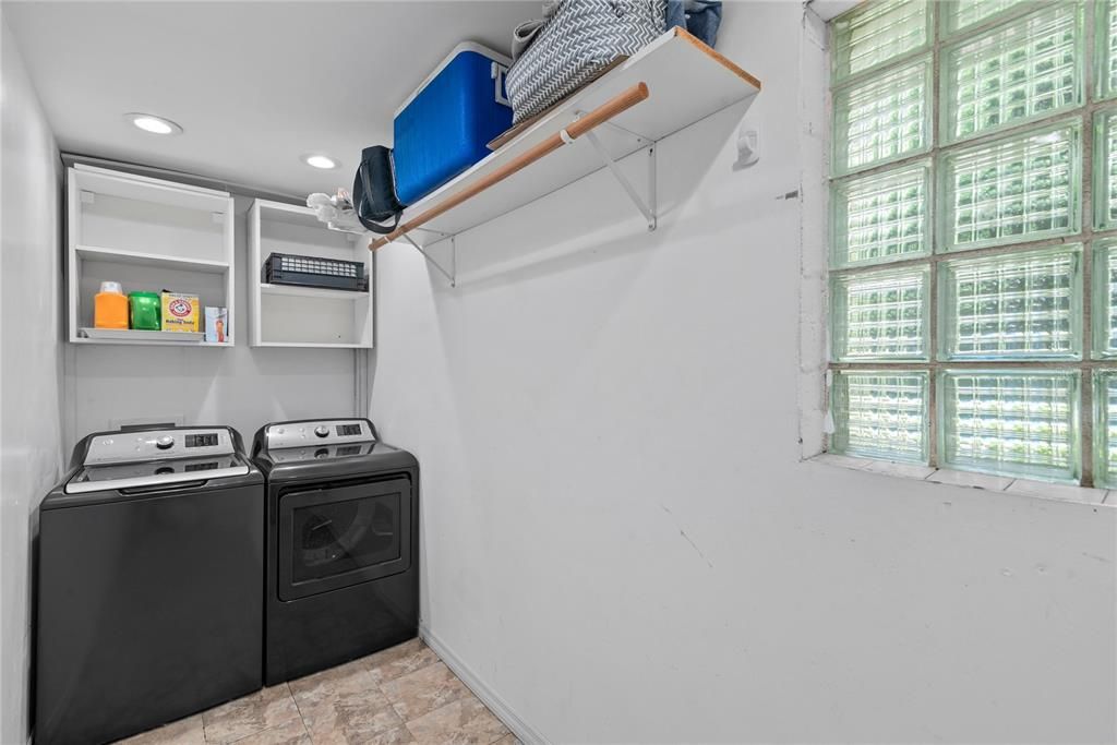 Laundry room is accessed through kitchen. A door separates kitchen from laundry room.