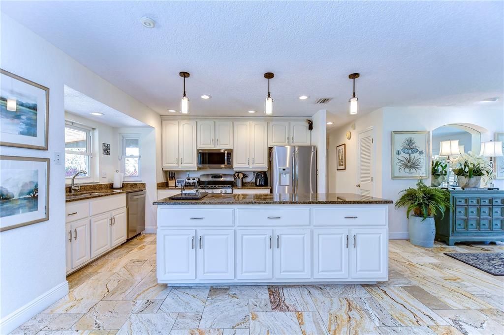 Chefs kitchen with white cabinets and stainless appliances!