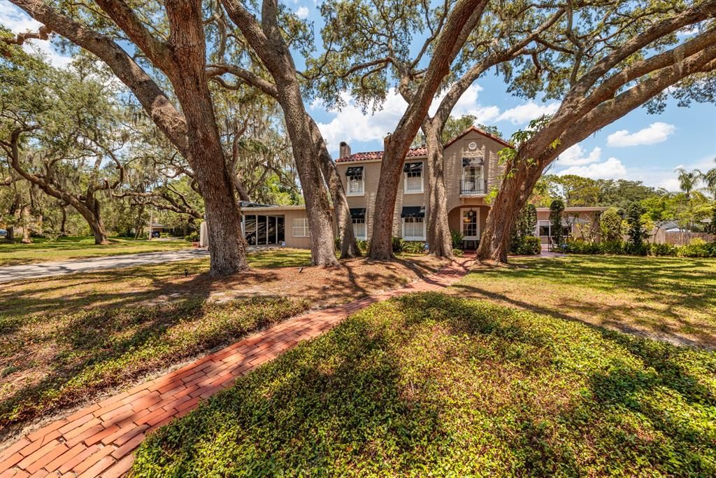 This beautiful home is shaded by a lovely canopy of well maintained oaks