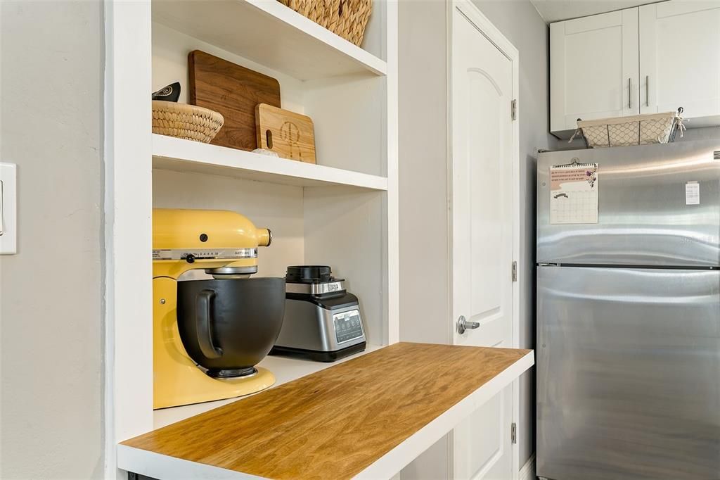 Great built- in for displaying your favorite kitchen items. The  pull out shelf/table offers an additional baking/mixing area.