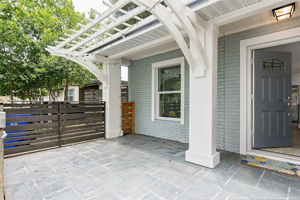 Great front porch with pergola and tiled entry to welcome guests. Room for many different seating or dining configurations.