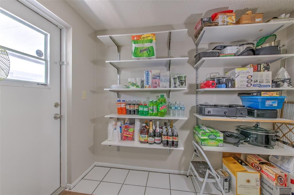 Laundry Room, Large Pantry with adjacent View of patio side entrance & storage room that is adjacent to the Laundry Room.